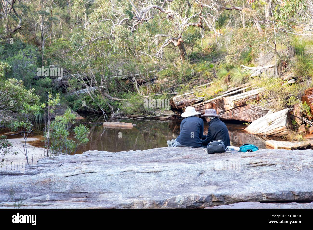 Royal National Park Sydney, Wanderinnen mittleren Alters machen eine Pause neben dem Deer Pool in Australiens erstem Nationalpark Stockfoto