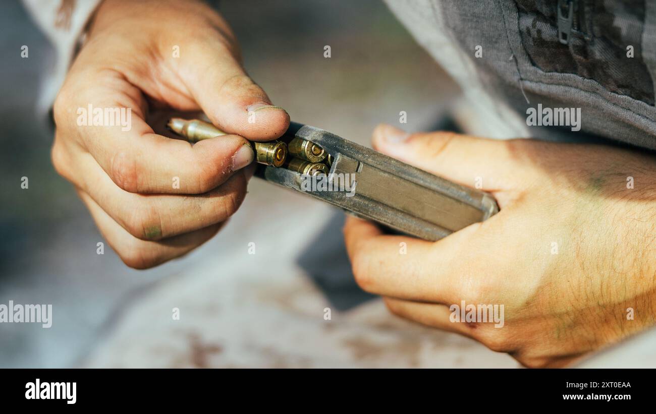 Ein U.S. Marine mit Golf Company, 2d Bataillon, 2d Marine Regiment, 2d Marine Division lädt Munition in ein Magazin während eines Unit Enhancement Training 24-2 UET 24-2 Events mit Soldaten der Vereinigten Arabischen Emirate im Marine Corps Base Camp Lejeune, North Carolina, 31. Juli 2024. Die UET 24-2 bestand aus einer Reihe von kombinierten Rüstungsoffensive- und Aufstandsbekämpfungsoperationen auf Platoon-Ebene, die die Leistungsfähigkeit, taktische Bereitschaft und Interoperabilität zwischen dem Marinekorps und ausländischen Partnern verbesserten. (Foto des U.S. Marine Corps von Lance CPL. Hunter J. Kuester) Stockfoto