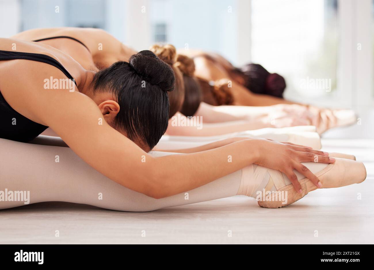 Gruppe, Stretching und Training für den Unterricht für Ballett, Frauen und selbstbewusst für Fitness, Balance und Rudern. Ausbildung, Leute und professionelle Tänzerin mit Stockfoto