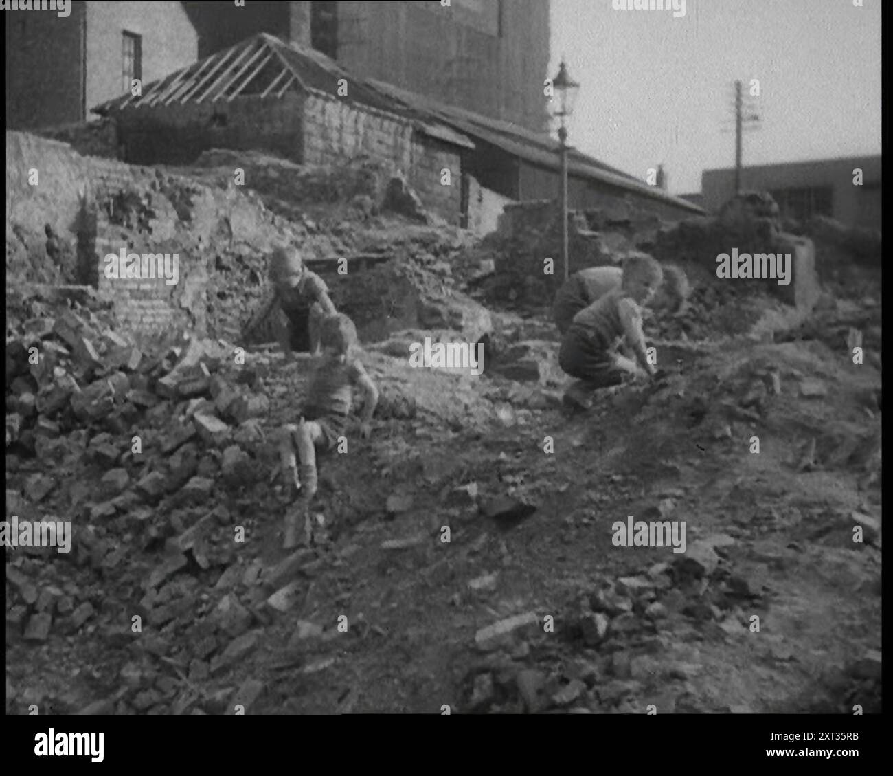 Kinder, Die Draußen Spielen, 1933. Die große Depression in Großbritannien. „In [den] schwer getroffenen Tälern von Wales und auf Clydebank und Jarrow gingen die Regierungsvergaben nicht weit.“ Aus „Time to Remember – The Time of the Monster“, 1933 (Reel 3); ein Dokumentarfilm über die Ereignisse von 1933, Rise of Roosevelt und Hitler. Stockfoto