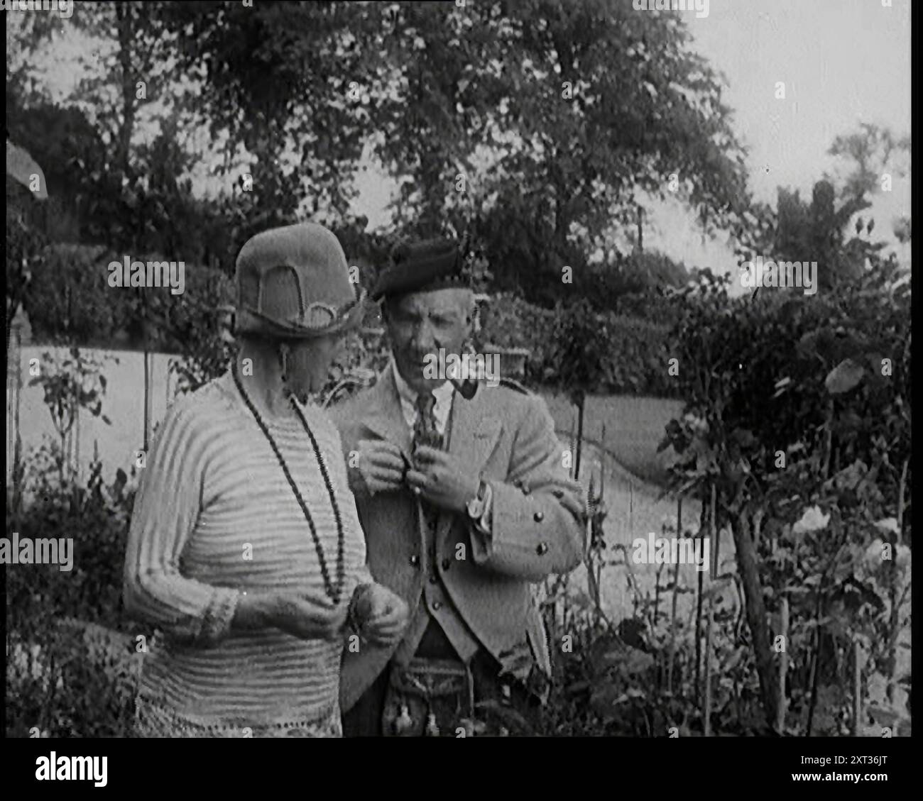 Sir Harry Lauder schenkt Blumen seiner Frau Lady Ann Lauder, zu Hause in Schottland, 1920er Jahre Aus „Time to Remember – On Stage in the Twenties“, 1927 (Rolle 1); ein Blick hinter die Kulissen des Theaters in den 1920er Jahren Stockfoto