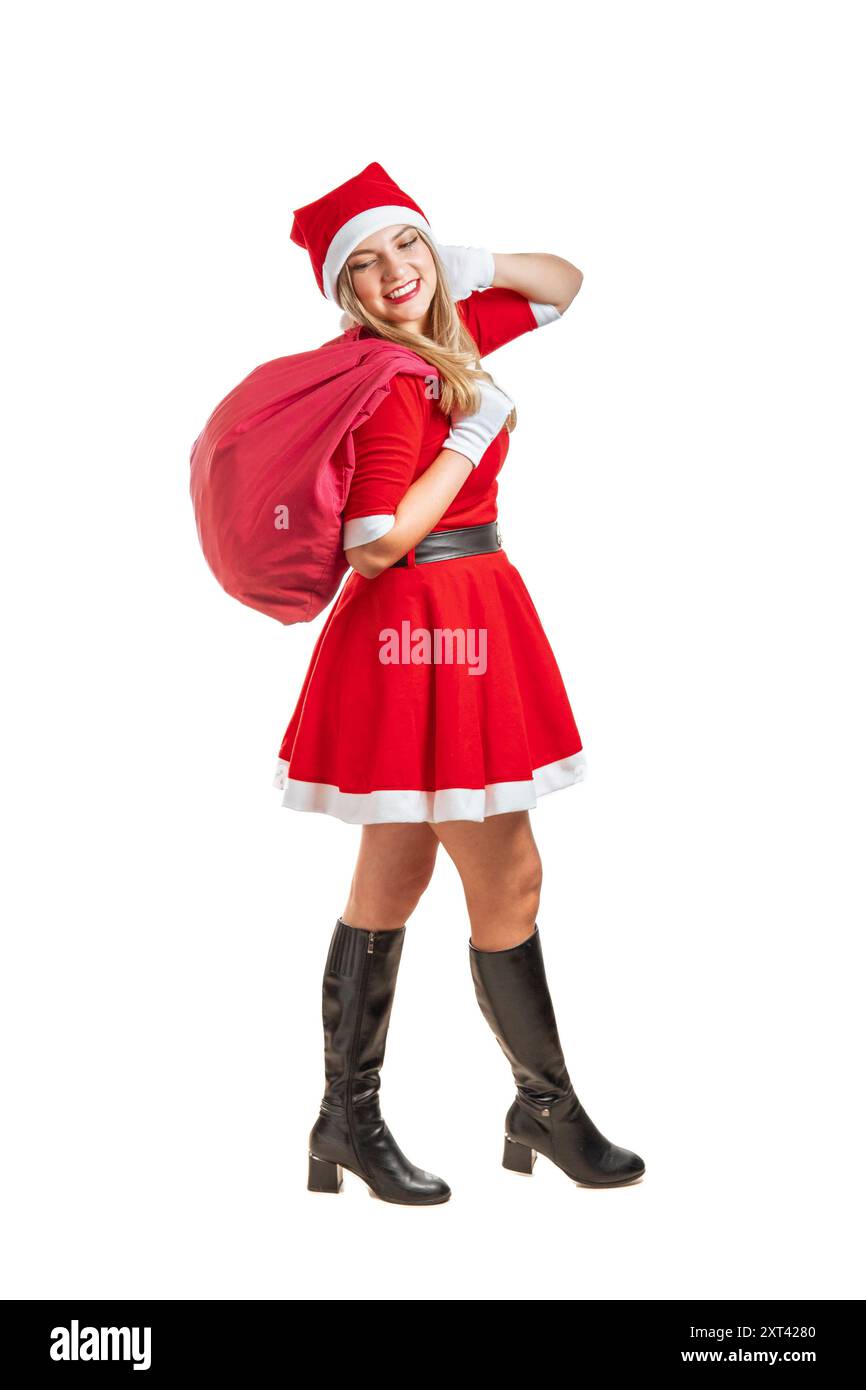 Junge Frau im weihnachtsmannkostüm, die mit einer roten Geschenktüte an weihnachten auf weißem Hintergrund läuft Stockfoto