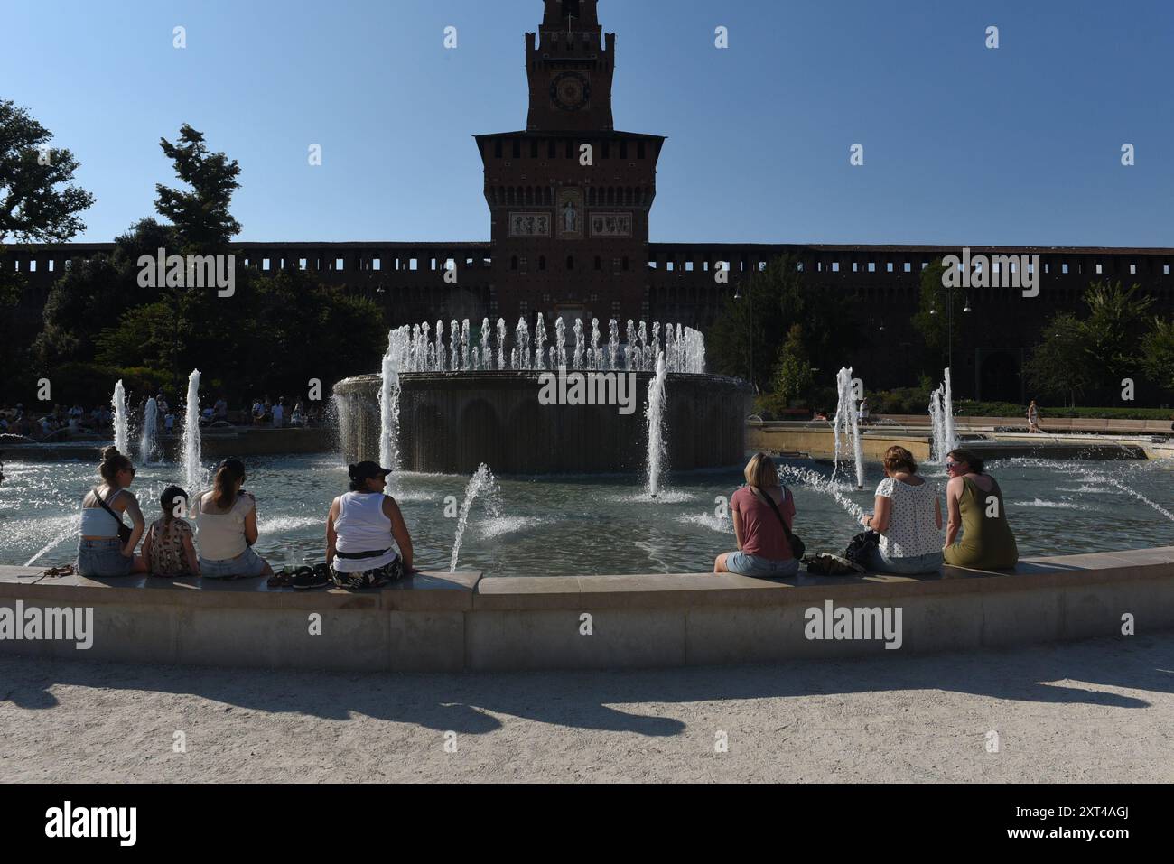 Mailand, Italien. August 2024. Touristen suchen nach einer Erfrischung im Brunnen vor dem Schloss Sforza. Die Hitzewelle, die Italien getroffen hat, hält an, mit Temperaturen von bis zu 41 Grad, die vor zwei Tagen in Florenz, in der Toskana, verzeichnet wurden. Die Situation sollte sich verbessern, sogar mit einem Rückgang der Mindesttemperaturen, ab dem Wochenende (Credit Image: © Ervin Shulku/ZUMA Press Wire) NUR REDAKTIONELLE VERWENDUNG! Nicht für kommerzielle ZWECKE! Stockfoto