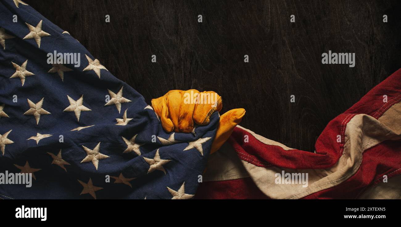 Getragener Arbeitshandschuh mit US-amerikanischer Flagge. Made in USA, American Workforce, Blue Collar Worker oder Labor Day Concept. Stockfoto