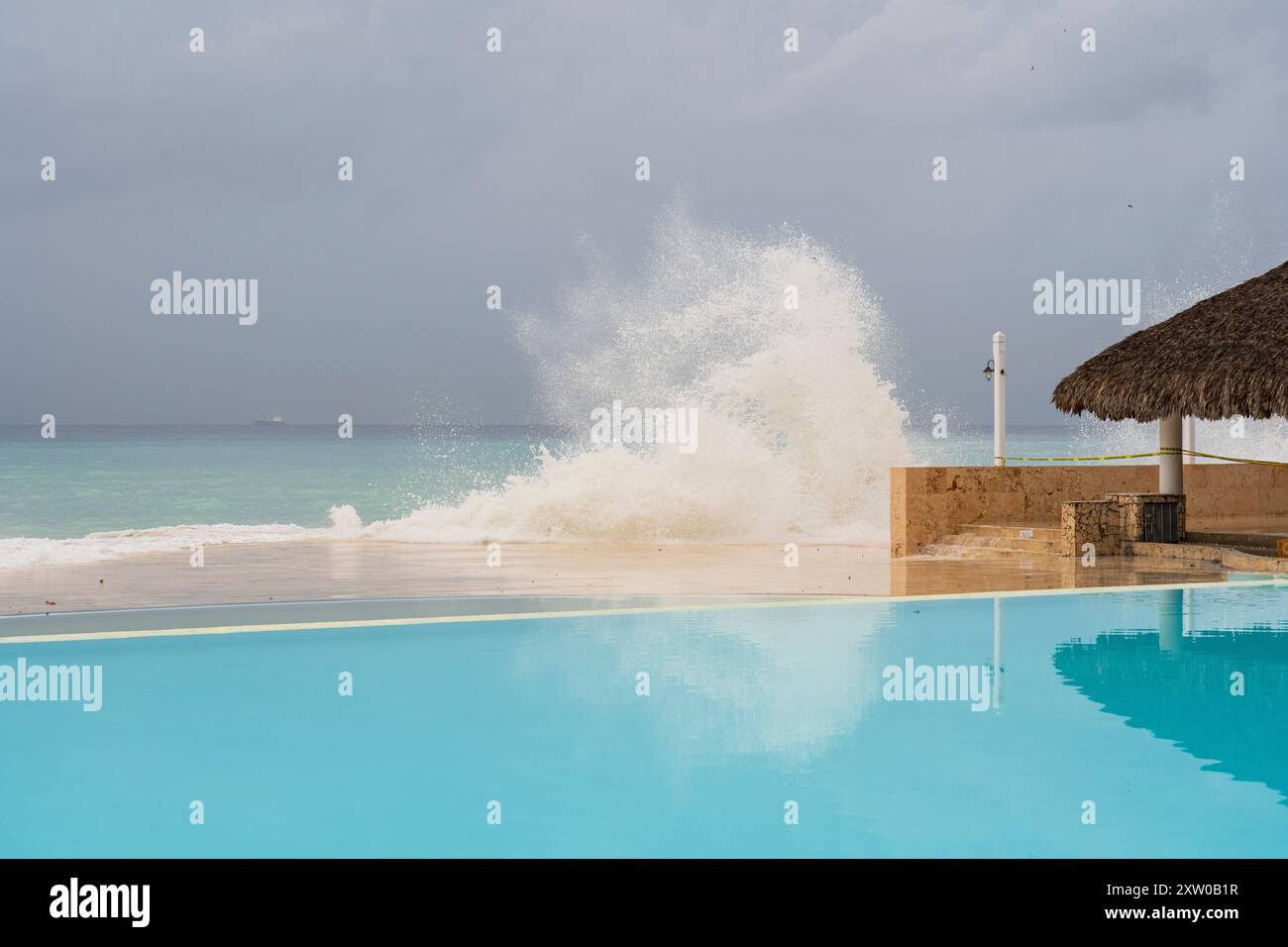 Wunderbares schweres Meer, große Wellen krachen in den Pool, Regenwolken im Hintergrund, Hurrikan kam nahe der Küste der Dominikanischen Republik, Bayahibe. Stockfoto