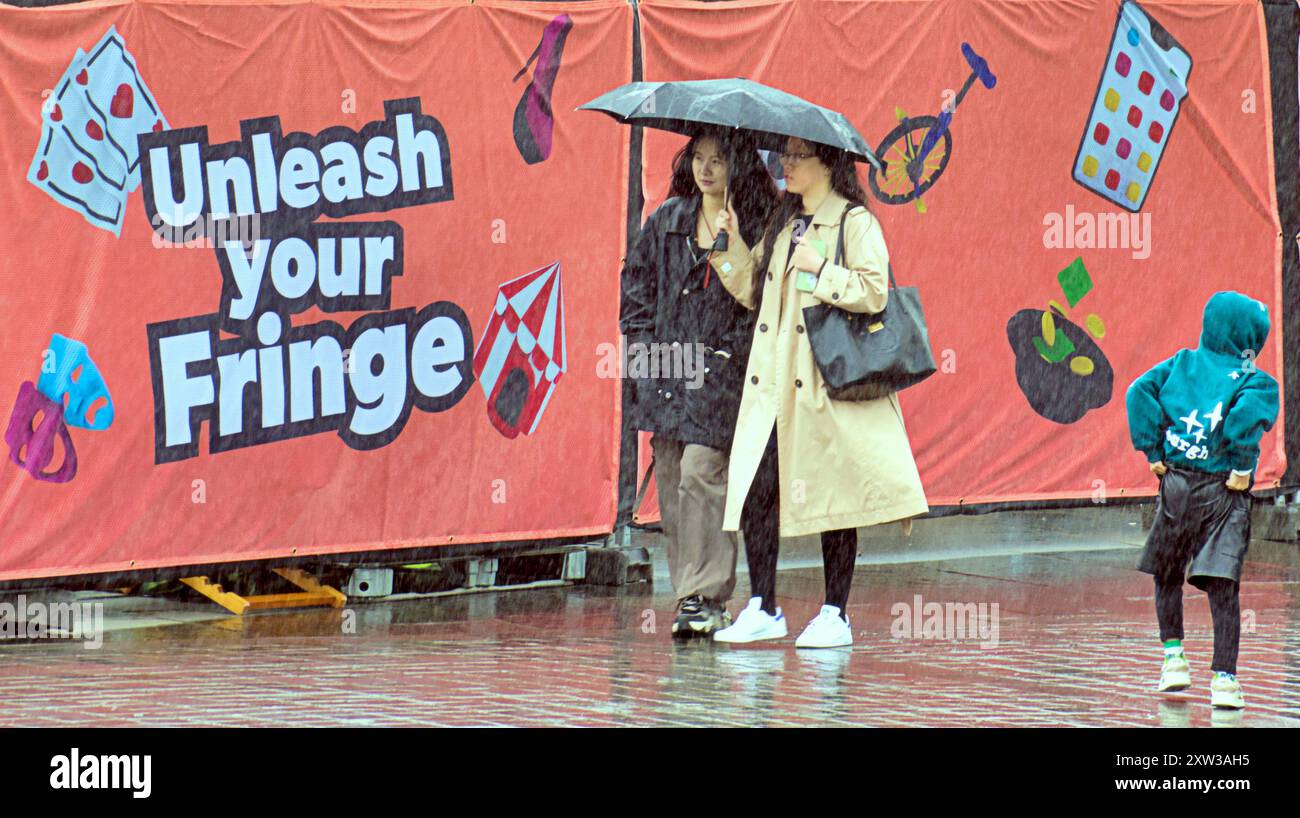 Edinburgh, Schottland, Großbritannien. August 2024. Wetter in Großbritannien: Wet Fringe auf der Royal Mile and Mound sah große Massen von Einheimischen und Touristen in der Stadt kämpfen im Regen. Credit Gerard Ferry/Alamy Live News Stockfoto