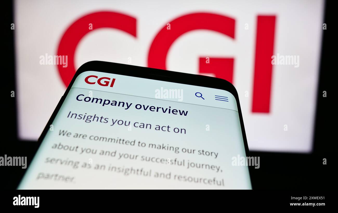 Mobiltelefon mit Website des kanadischen IT-Unternehmens CGI Inc. Vor dem Geschäftslogo. Fokussieren Sie sich oben links auf der Telefonanzeige. Stockfoto