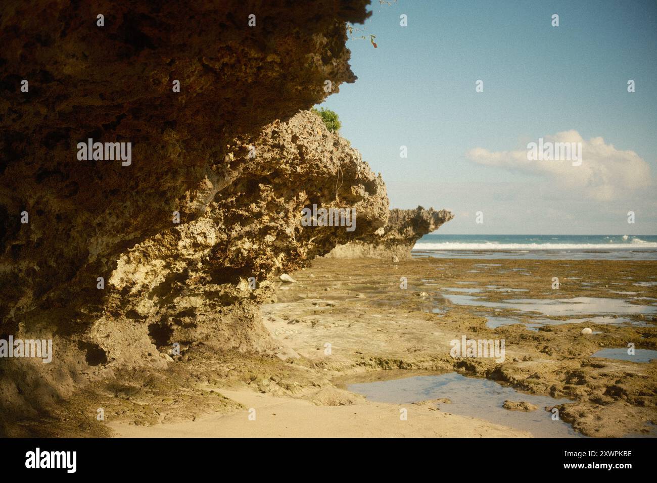 Klippenoberfläche erodiert durch Ozeanwellen mit Blick auf das zurückziehende Meer Stockfoto