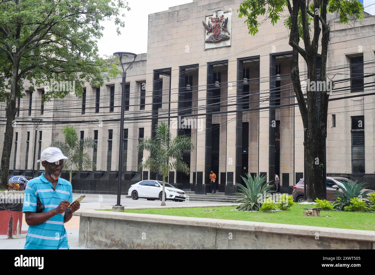 The country's coat of arms is displayed on the facade of a government ...