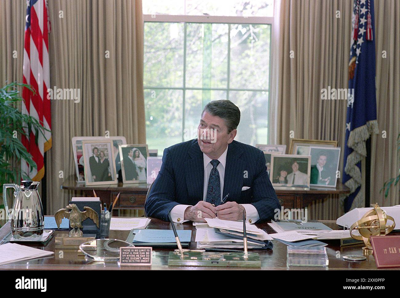 Präsident Reagan sitzt an seinem Schreibtisch im Oval Office. April 1988 Stockfoto