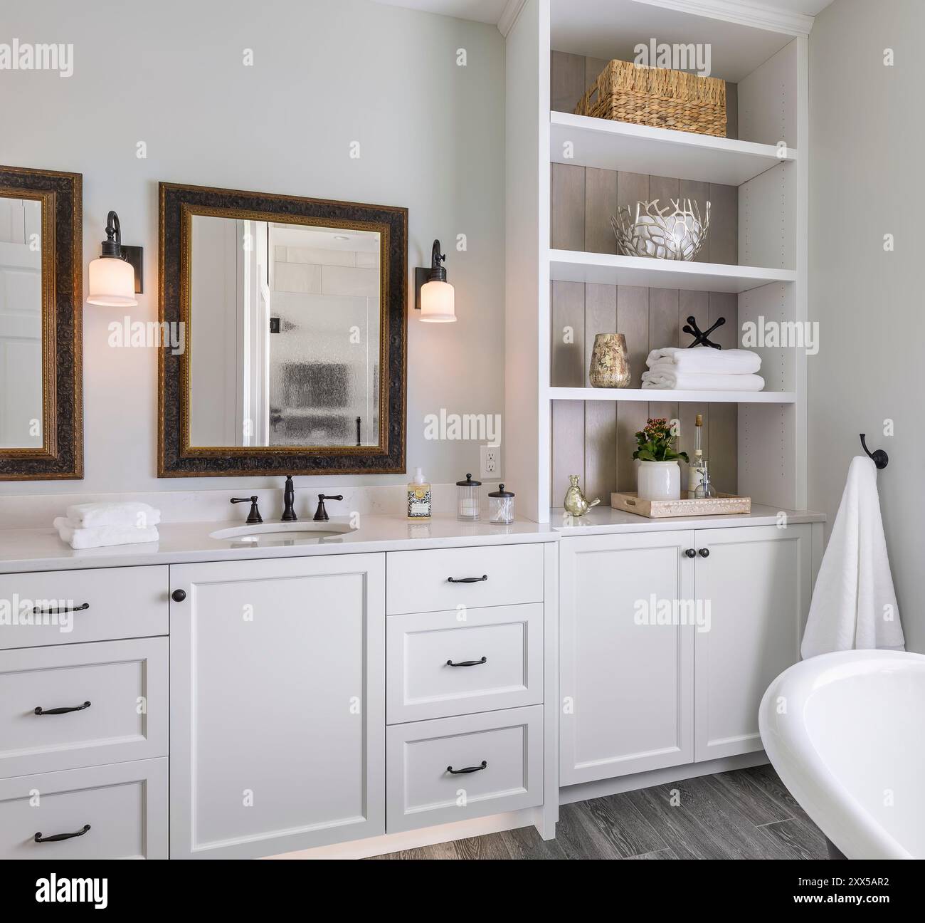 Kosmetikbereich im Bad mit eingebautem Regalschrank und Badewanne Stockfoto
