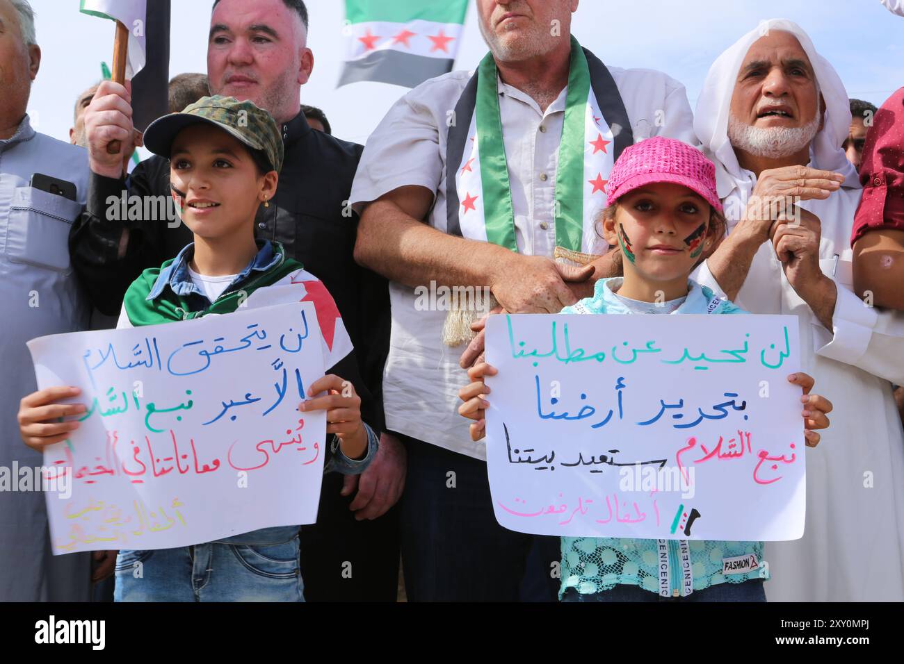 Azaz, Syrien. 11. Oktober 2019. Syrer, die ursprünglich aus Dörfern stammen, die von den syrischen Demokratischen Kräften (SDF) und der kurdischen PKK kontrolliert werden, demonstrieren durch den Grenzübergang Bab al-Salama im Nordosten Syriens, um die türkische Militäroffensive „Friedensfrühling“ in Nordsyrien zu unterstützen. Erwachsene und Kinder bekundeten ihre Unterstützung für die kürzlich begonnene Militäroperation der Türkei und der von der Türkei unterstützten Freien Syrischen Armee, offiziell bekannt als syrische Nationalarmee, östlich des Euphrats, und forderten die Befreiung ihrer Dörfer und Städte. Mehr als 250.000 Menschen waren hier Stockfoto