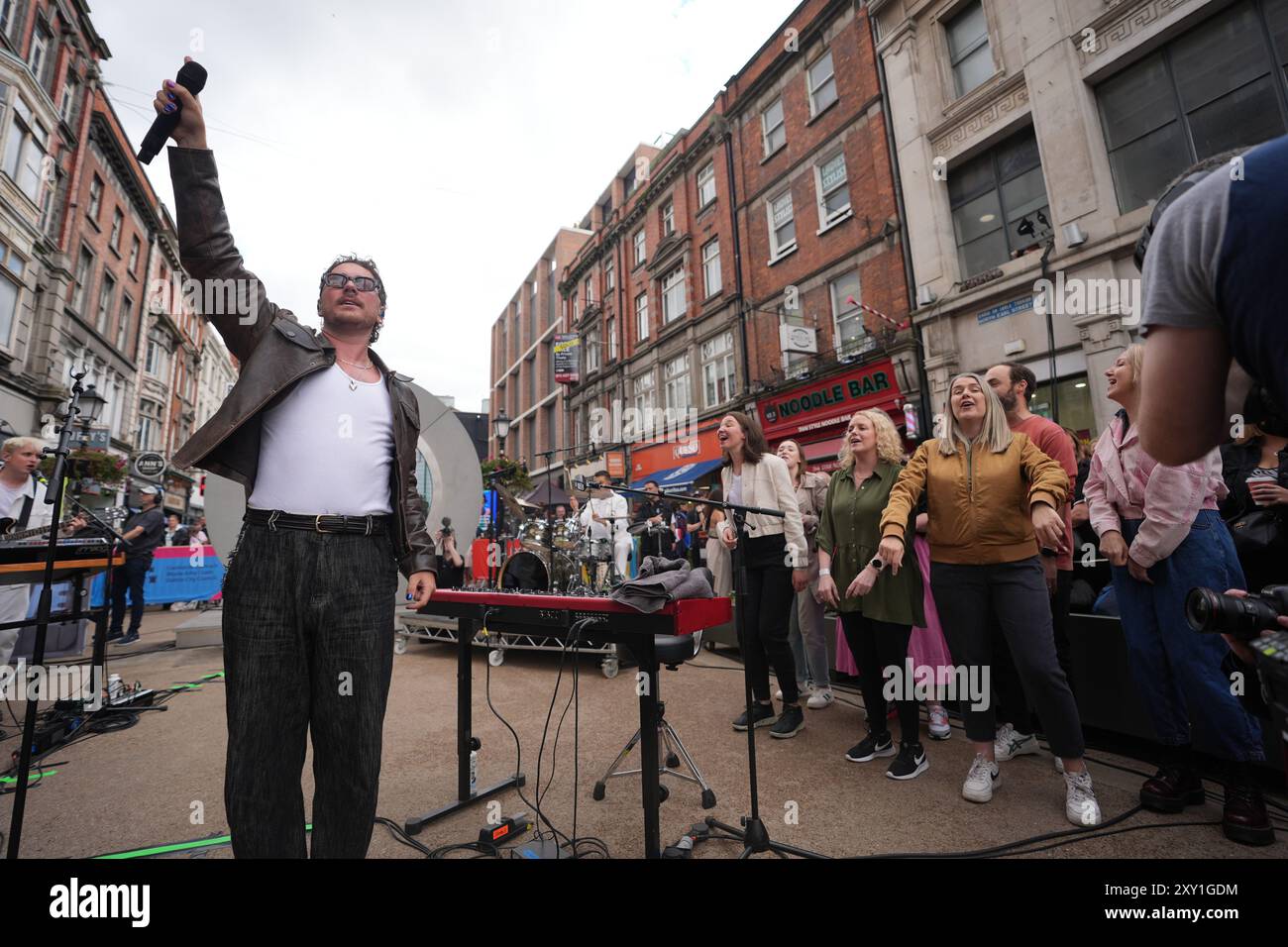 Cian Ducrot und Flash Mob Choir treten auf dem Dublin-Portal auf und streamen live nach New York, Vilnius und Lublin. Bilddatum: Dienstag, 27. August 2024. Stockfoto