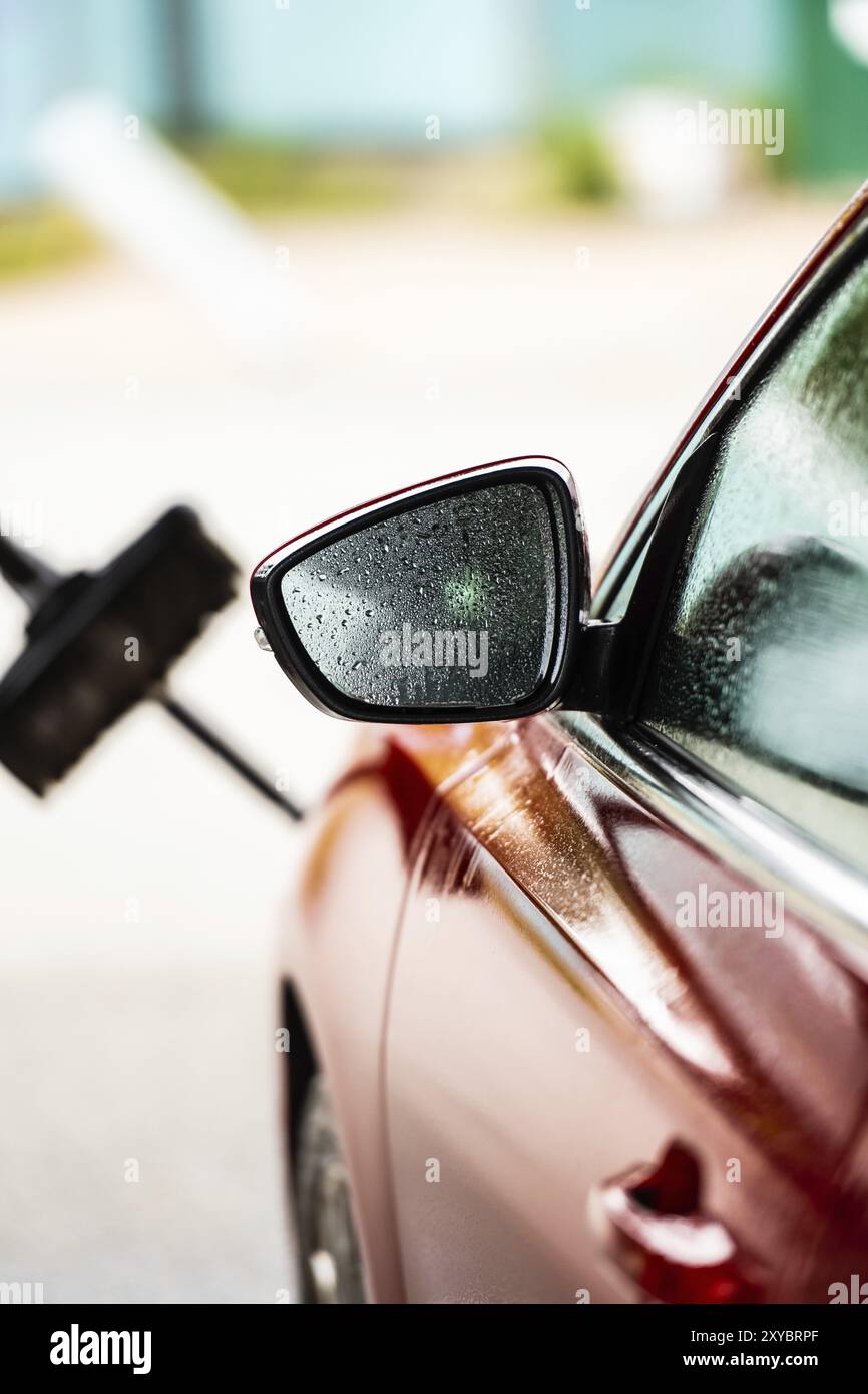 Ein rotes Auto waschen und reinigen Stockfoto