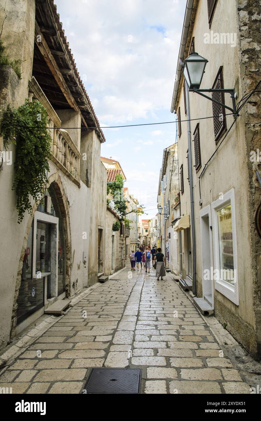 Kroatien, 28 08 2014: Blick auf eine enge Straße auf der Insel mit Touristen zu Fuß und kleinen Souvenirläden und Restaurants, Touristenattraktion, Euro Stockfoto