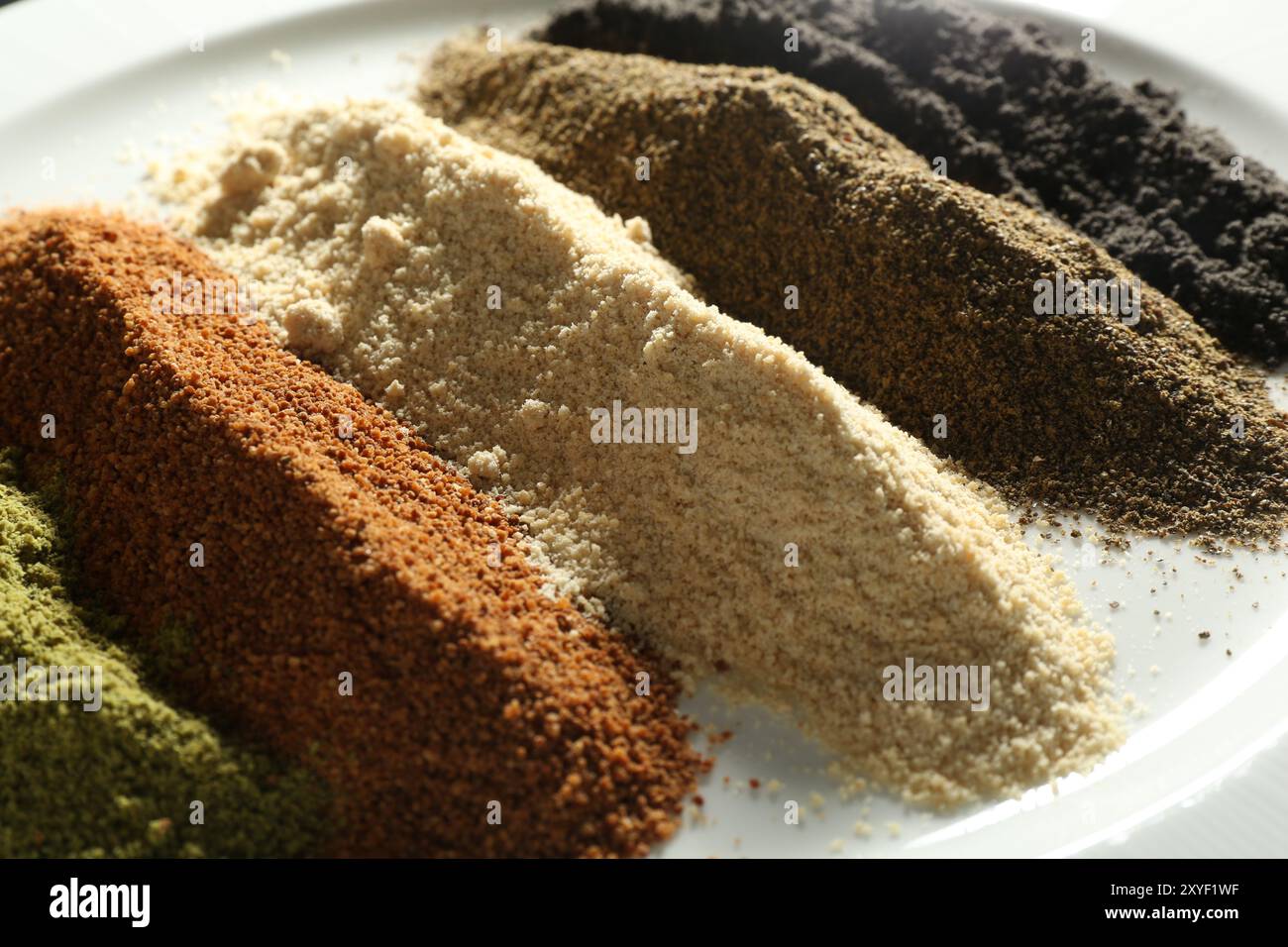 Verschiedene Superfood-Pulver auf dem Teller, Nahansicht Stockfoto