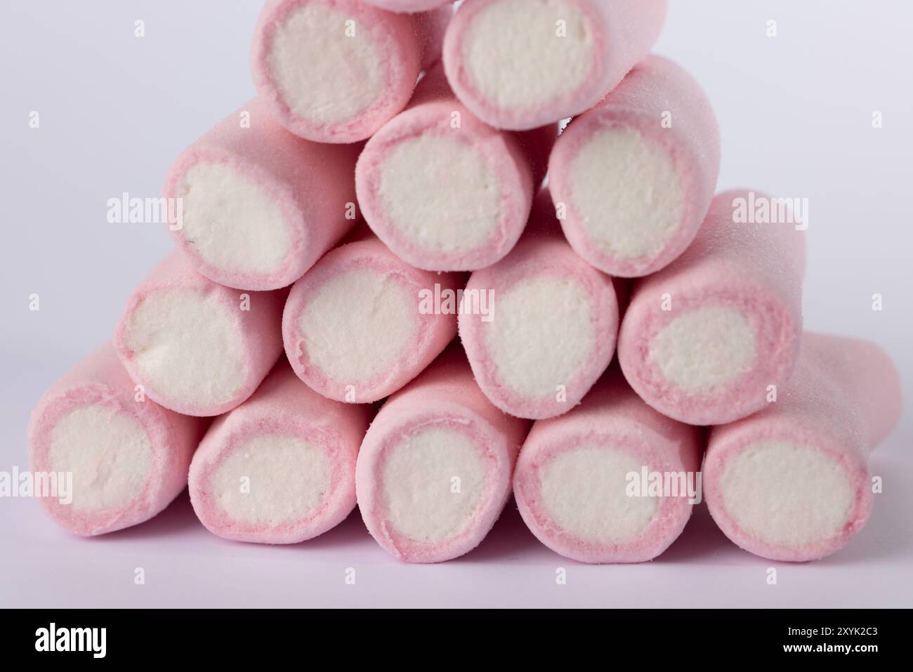 Nahaufnahme eines pyramidenförmigen Stapels von Marshmallows, zentral auf einem sauberen weißen Hintergrund platziert. Das Bild zeigt die weiche, weiße Textur und den Stru Stockfoto