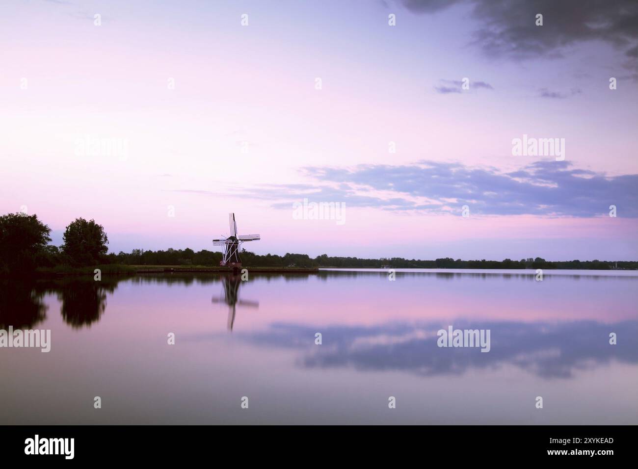 Windmühlenspiegelung im großen See bei Sonnenuntergang Stockfoto