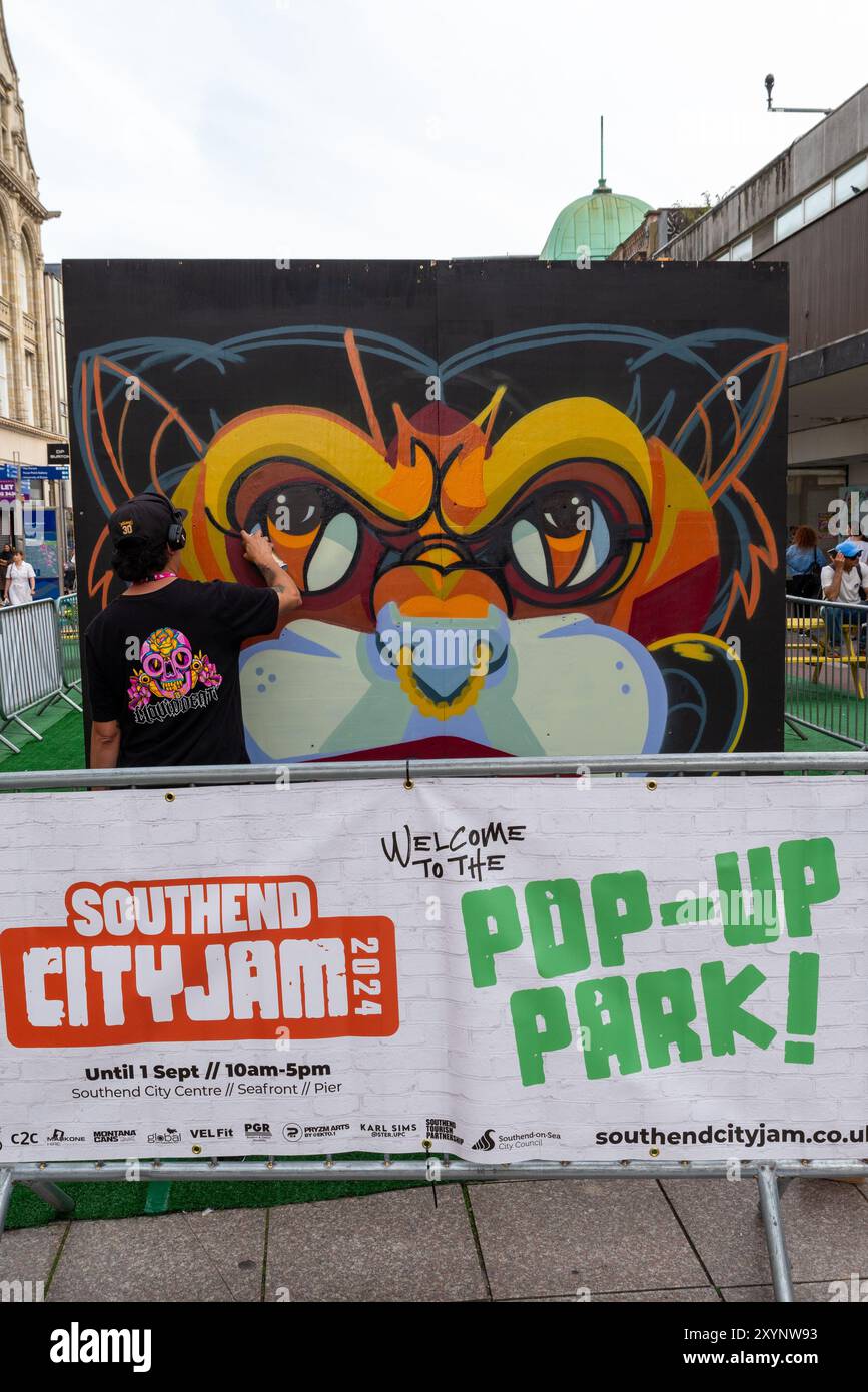 Southend on Sea, Essex, Großbritannien. 30. August 2024. Southend feiert seinen Stadtstatus mit dem City Jam Event. Mehr als 200 lokale, nationale und internationale Straßenkünstler zeigen ihr Können an verschiedenen Orten im Stadtzentrum. Einige temporäre Mauern wurden errichtet, aber die Künstler dekorieren auch die Seiten von Gebäuden, Häusern und anderen dauerhaften Bauten. Hier in der High Street können Künstler an den Wandmalereien in den Straßen und Grundstücken arbeiten Stockfoto