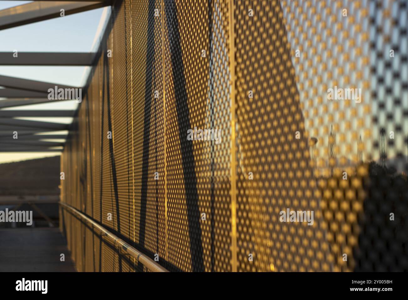 Aluminiumverbundplatten oder -Verkleidungen mit Lochblechen auf moderner Gebäudefassade bei Sonnenuntergang, abstraktes Architekturhintergrundkonzept Stockfoto