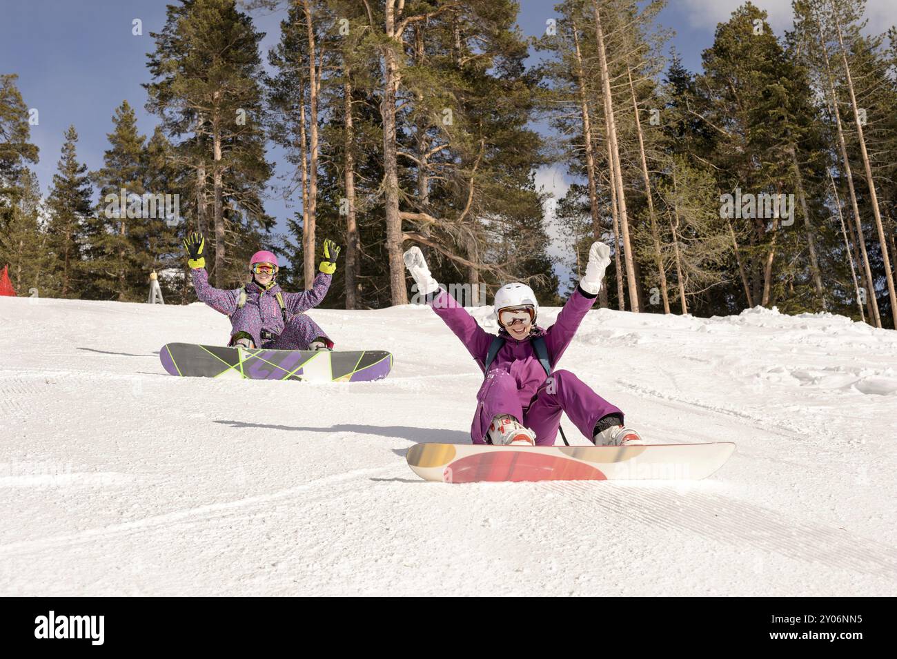 Zwei Freunde sitzen auf den Skipisten, Snowboardermädchen Stockfoto