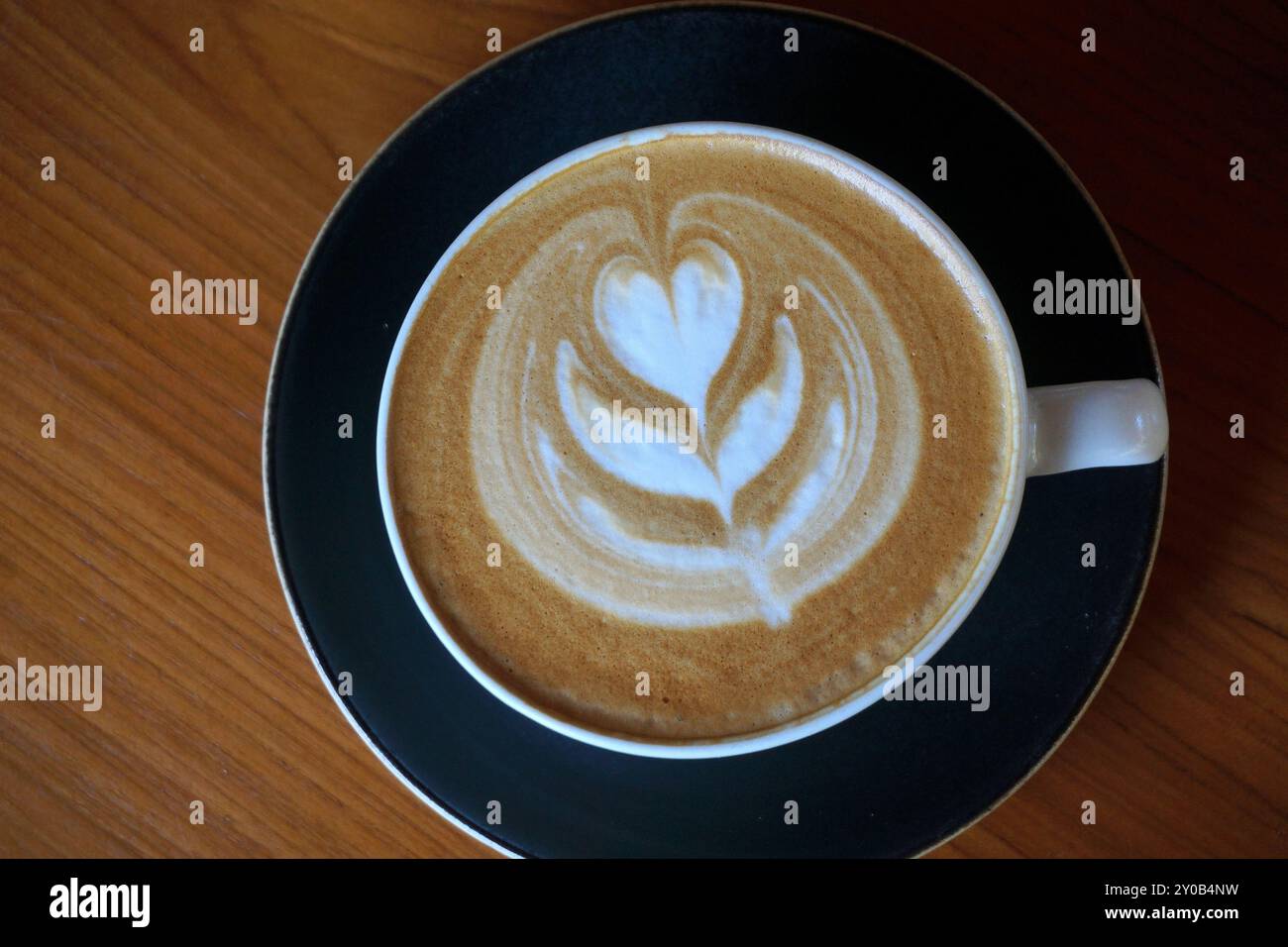 Tasse heißen Latte Art Kaffee auf Holztisch Stockfoto