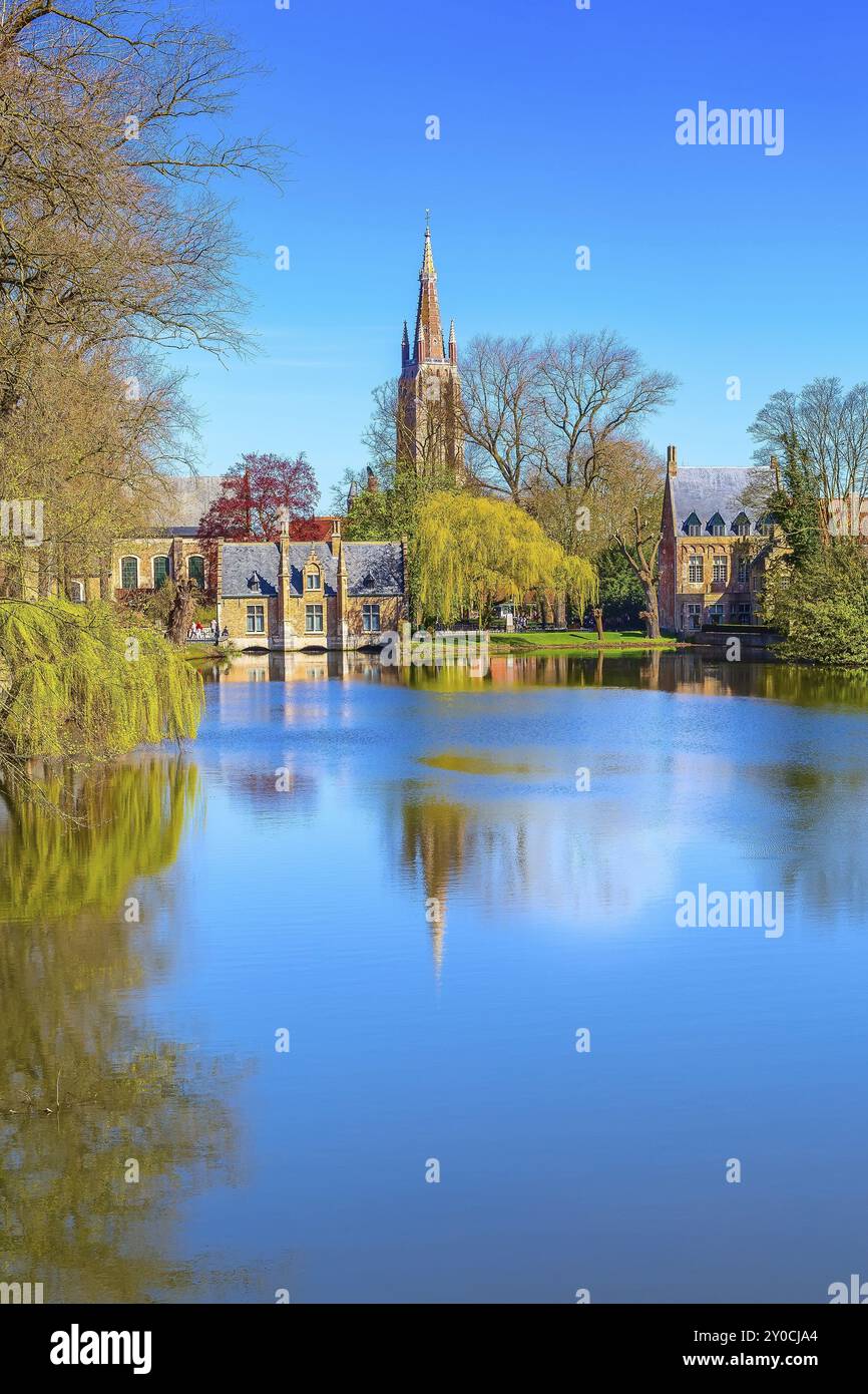 Minnewater Lake Panorama, Reflexion eines gotischen flämischen Hauses, blauer Himmel, Frühlingsbäume in Brügge, Belgien, Europa Stockfoto