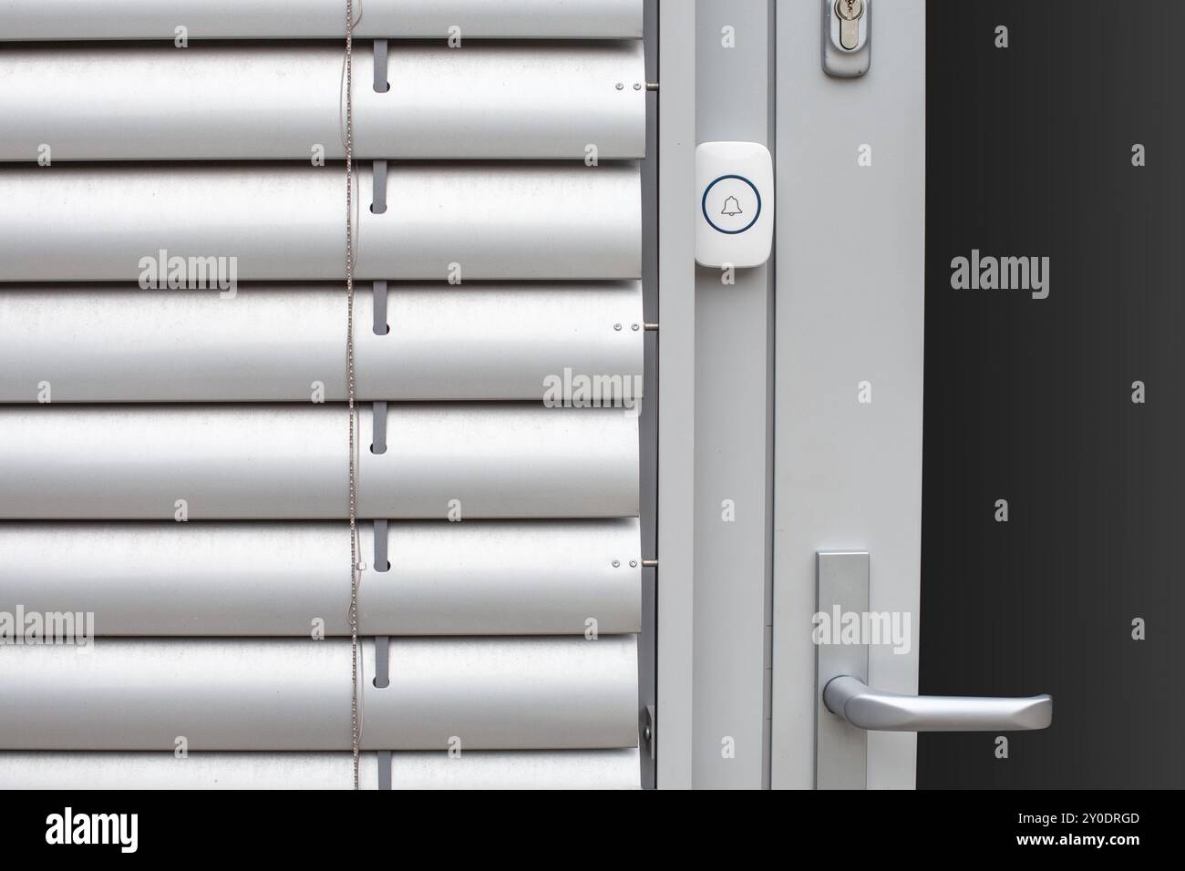 Moderne Tür mit kabelloser Türklingel und Metallgriff Stockfoto