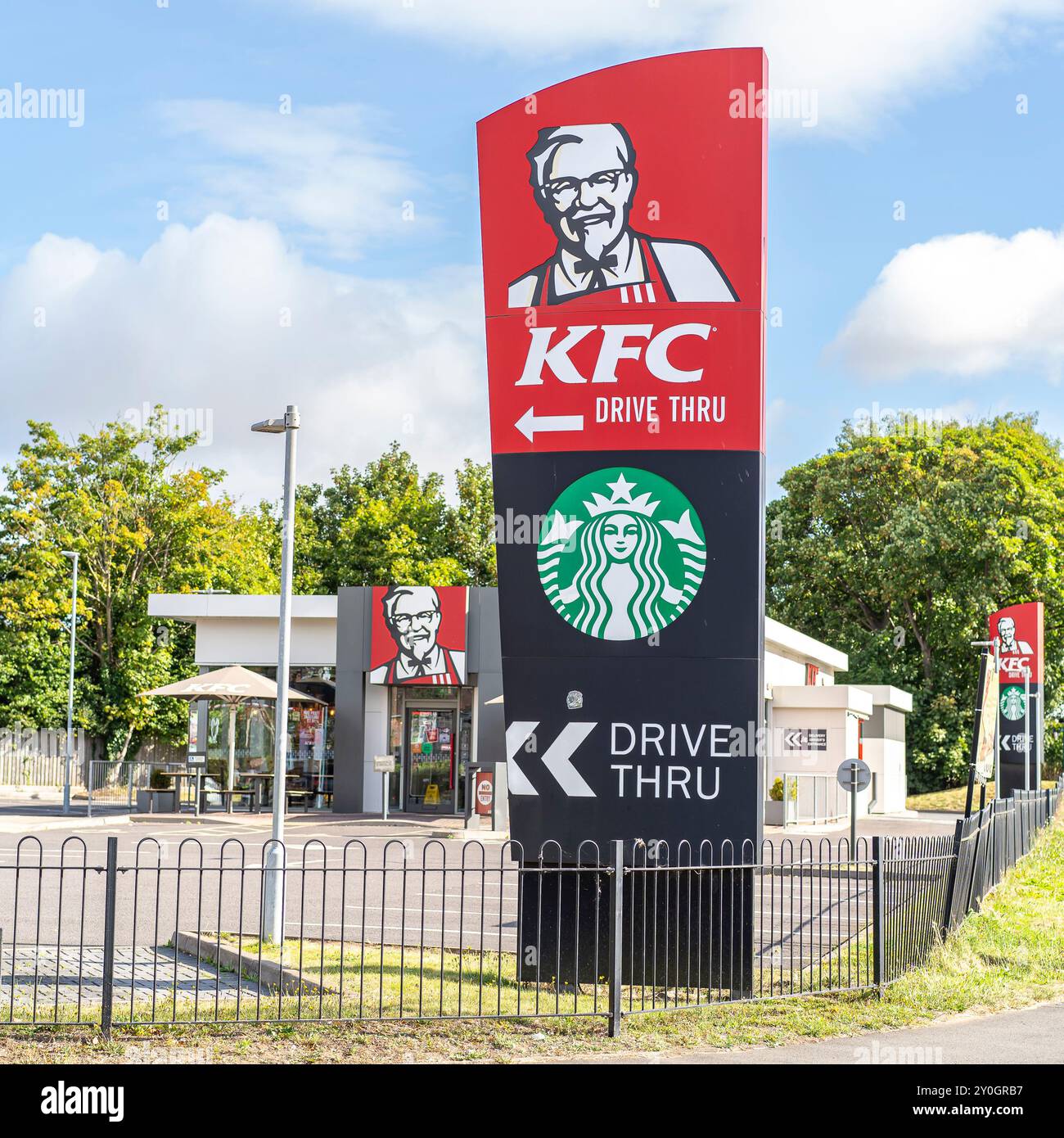 Beschilderung für ein KFC und Starbucks Drive-Thru Restaurant an einem hellen sonnigen Tag. Stockfoto