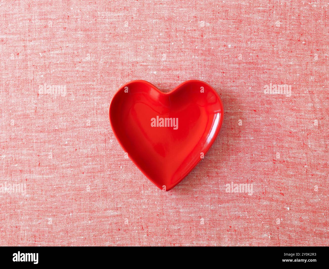 Rotes und weißes Tuch und eine herzförmige Schale in roter Form Stockfoto