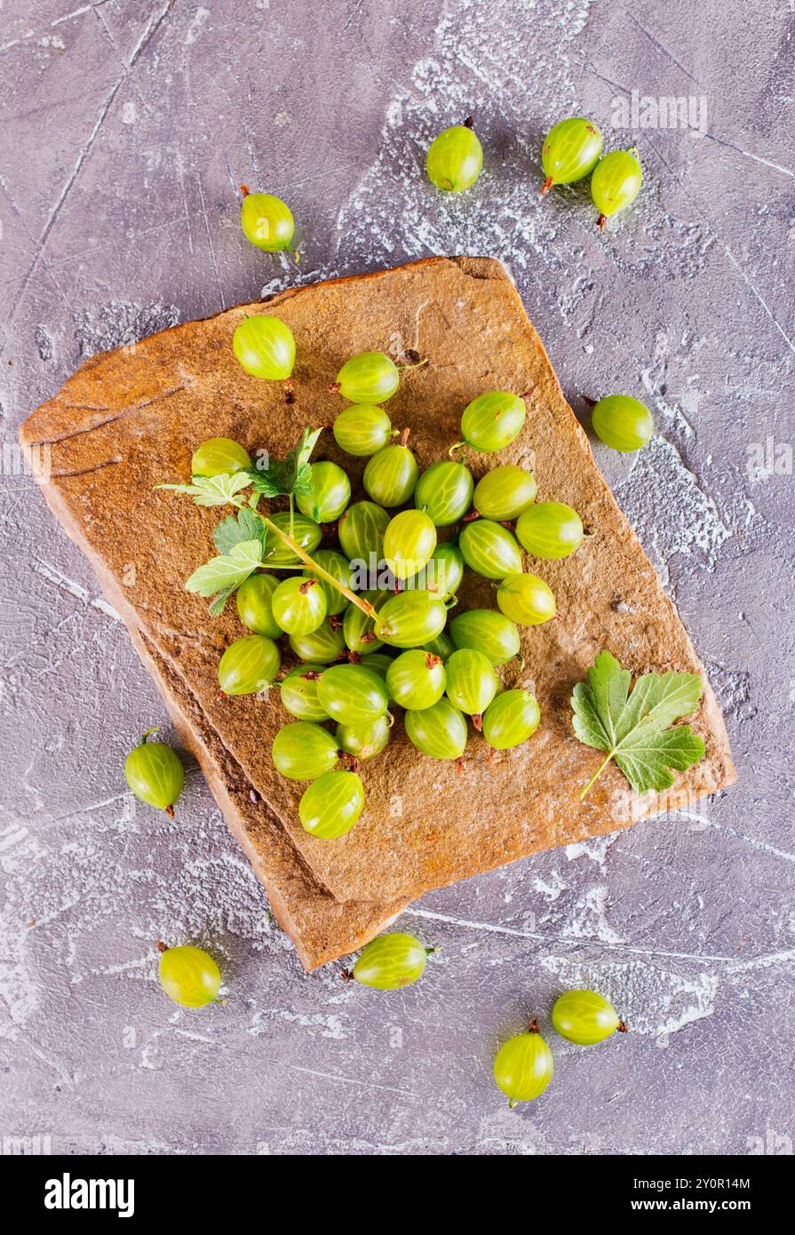 Frische Bio-Stachelbeeren in einer Holzschale auf einem Tisch Stockfoto