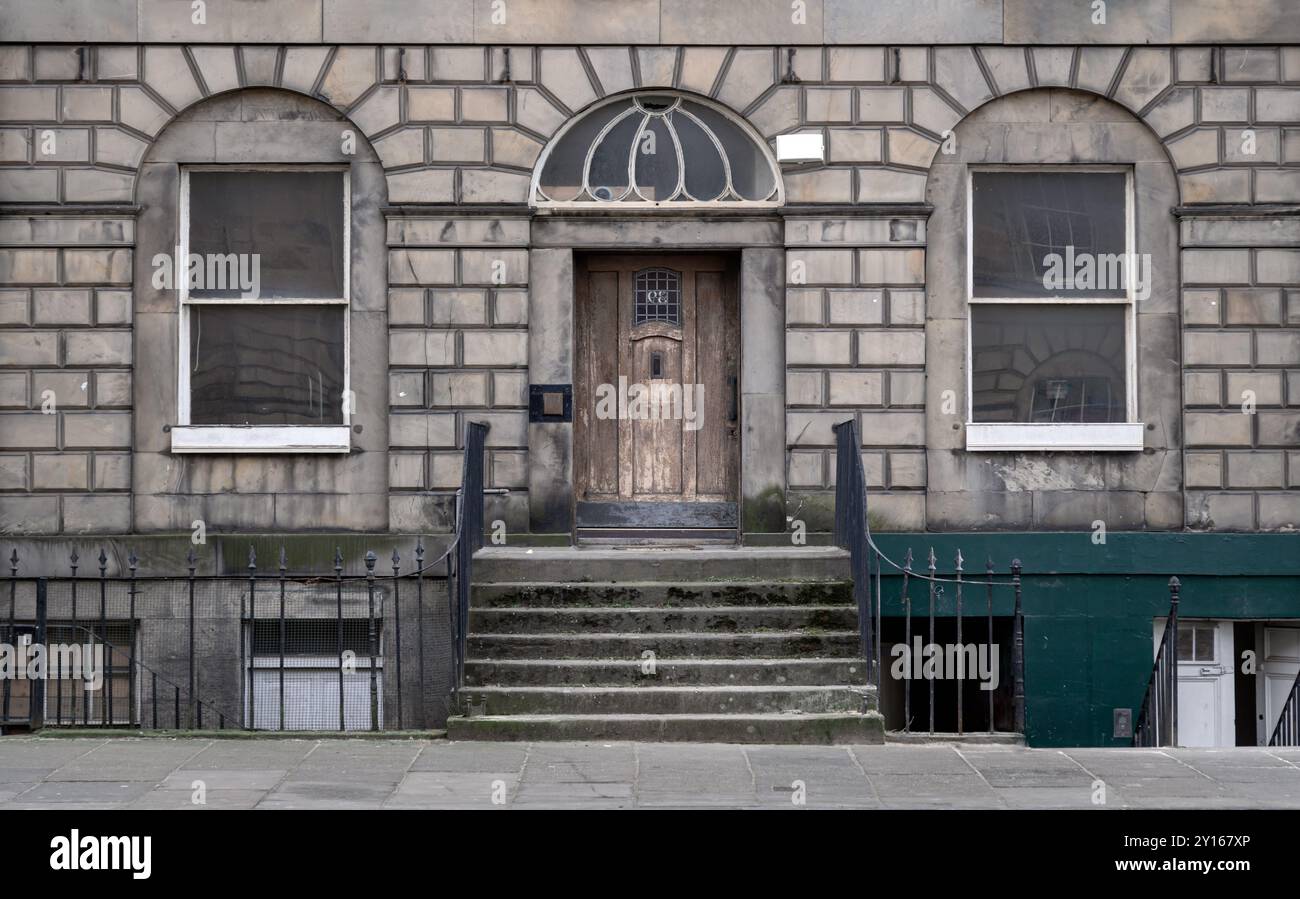 Edinburgh, Schottland - 16. Januar 2024 - georgianische Architektur des Hauses in Edinburgh. Fassade eines traditionellen Hauses mit Schiebefenstern, Holzeingang, Stein Stockfoto