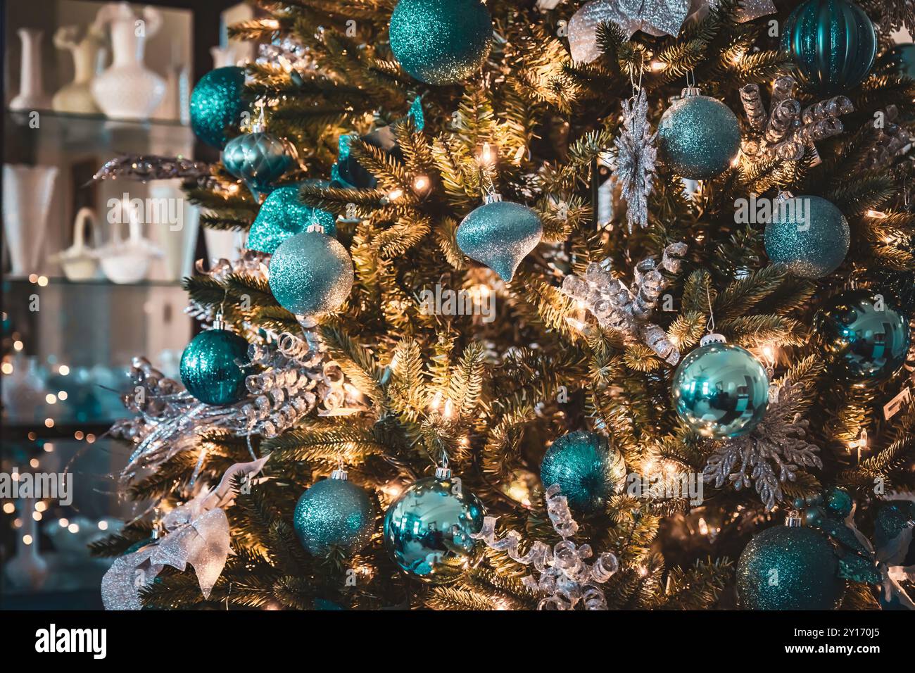 Nahaufnahme von Ornamenten, die an einem gut dekorierten Weihnachtsbaum in gemütlicher Atmosphäre hängen Stockfoto