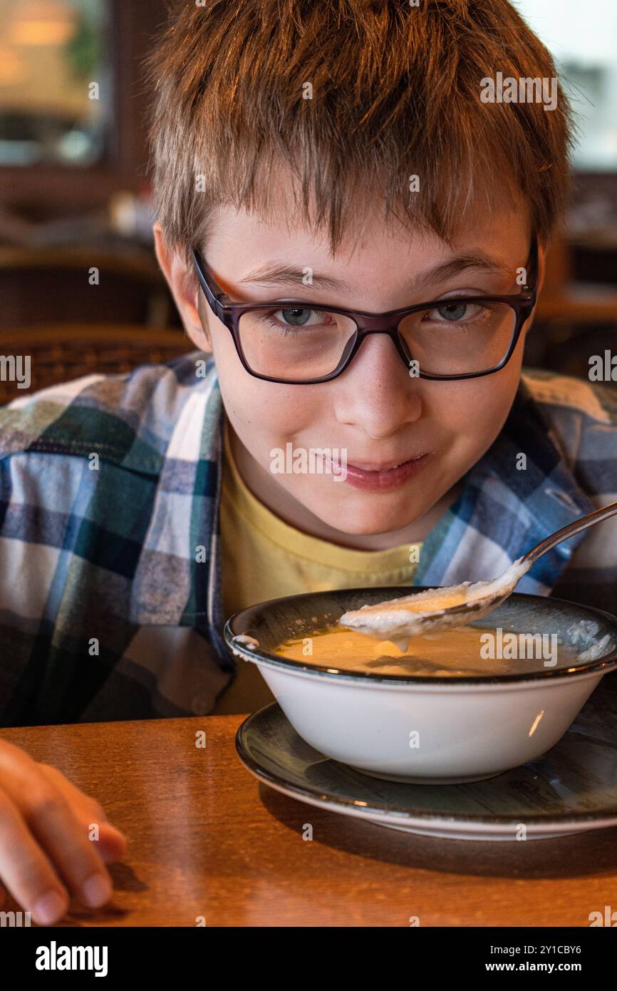 Teenager essen Haferbrei zum Frühstück Stockfoto