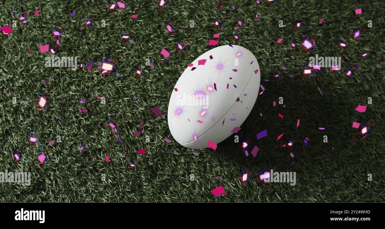 Bild von Konfetti über weißem Rugbyball auf Gras Stockfoto