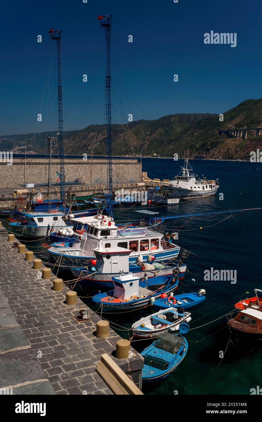 Speziell entworfene Schwertfisch-Fischerboote im Hafen von Scilla, einer Stadt in Kalabrien, Italien, mit Blick auf das Tyrrhenische Meer und die Meerenge von Messina. Jedes Boot hat einen hohen Mast mit einer Aussichtsplattform und, Meter von der Vorderseite des Bootes entfernt, eine lange Eisenbrücke, bekannt als passarella, die als Harponierplattform dient. Von Mai bis August machen sich Fischer auf den Weg, um Schwertfisch in der Straße zu fangen. Stockfoto