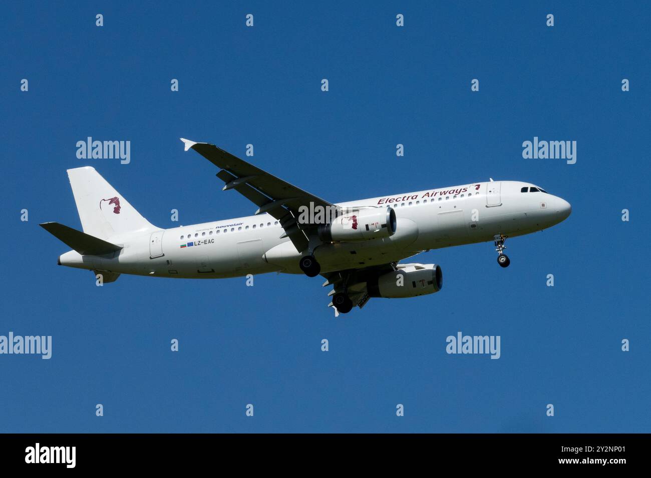 Ein weißes Passagierflugzeug Electra Airways Flugzeug Airbus A320 im Flug vor klarem blauem Himmel, als es sich zur Landung Leipzig Deutschland nähert Stockfoto