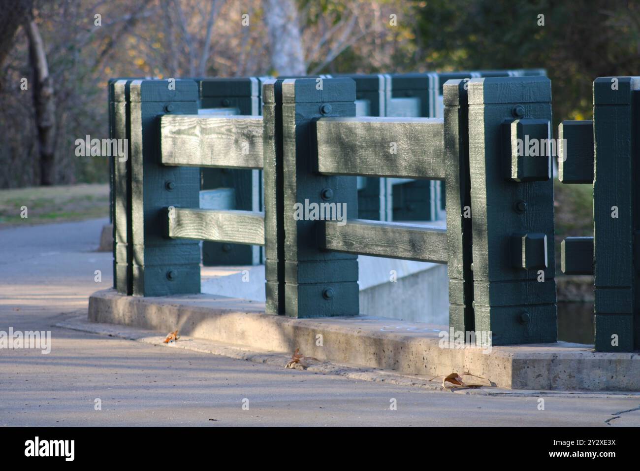 Grüner Holzzaun in der Nähe des Bürgersteigs im Park Stockfoto