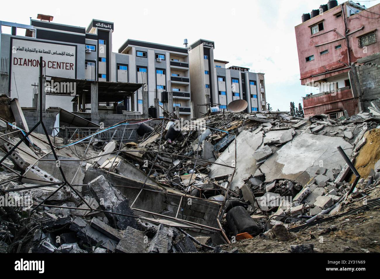 Gaza, Palästina, 26. März 2019. Die Palästinenser bewerten die Schäden am Standort des Multazim-Versicherungsgebäudes, das am 25. März durch israelische Bombardements im Osten von Gaza-Stadt zerstört wurde. Israelische Kampfflugzeuge führten Dutzende von Luftangriffen im südlichen, mittleren und nördlichen Gazastreifen durch, nachdem eine Gaza-Rakete ein israelisches Haus nördlich von Tel Aviv in Zentralisrael getroffen hatte und sieben Israelis verletzt hatte. Israelische Kampfflugzeuge zielten auf Standorte der Hamas sowie Dutzende Wohn- und Geschäftsgebäude ab, und laut dem palästinensischen Gesundheitsministerium in Gaza leiden sieben Palästinenser Stockfoto