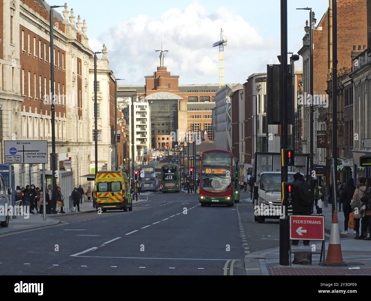 Leeds, West yorkshire, vereinigtes Königreich, 17. märz 2022: Busverkehr und Menschen in leeds mit Steinbruch am Ende der Straße Stockfoto