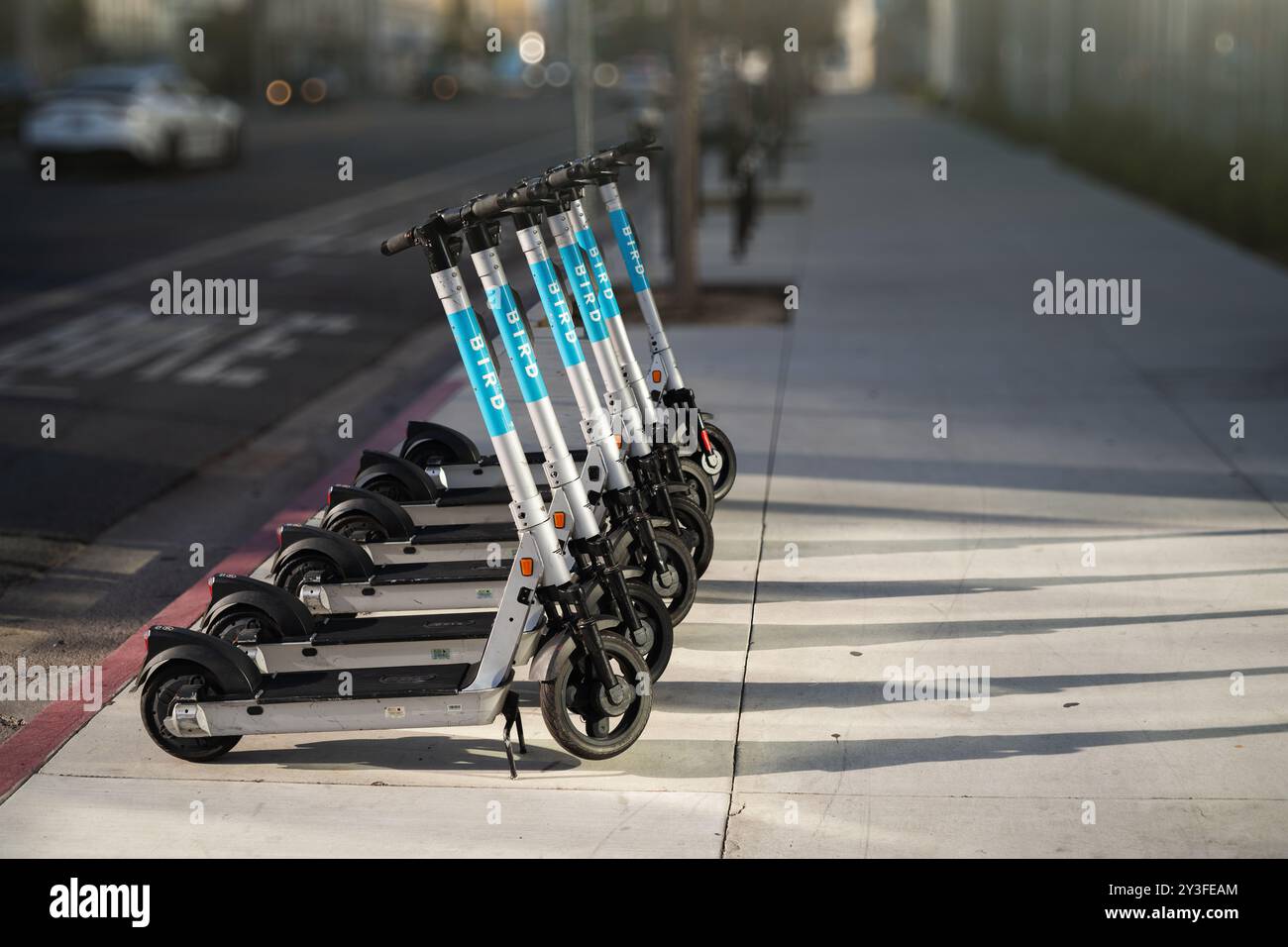 LOS ANGELES - 7. April 2024: Elektroroller, die bereit für eine Fahrt sind, stehen auf einer leeren Stadtstraße Stockfoto