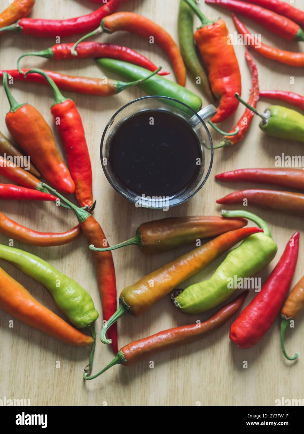 Vintage-Kaffee und farbenfrohe Chili-Paprika auf Holztisch Stockfoto