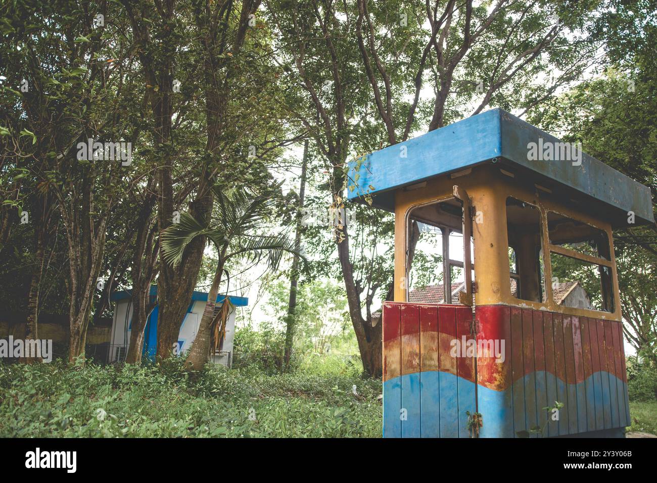 Verlassenes altes Gebäude mit bewachsenem Gras umgeben. Verlassenes Parkhaus. Stockfoto