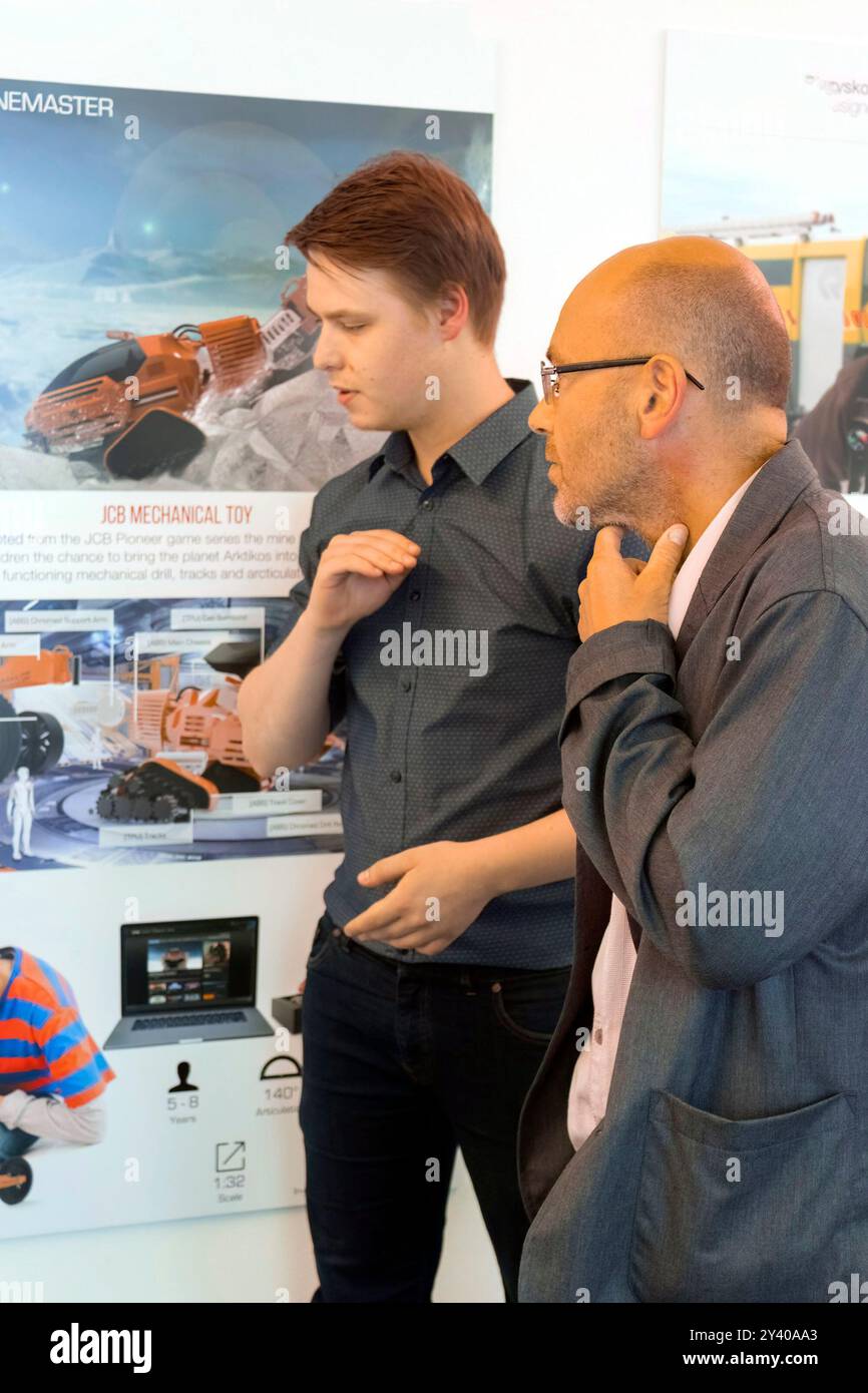 Designer wayne hemingway diskutiert Designarbeit mit Absolventen auf einer Designausstellung in großbritannien Stockfoto