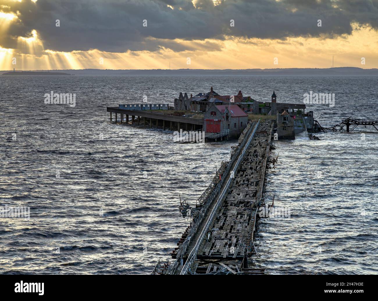 Der alte Birnbeck Pier in Weston Super Mare, Somerset, UK, der extrem verfallen und gefährlich ist, aber bald wieder restauriert werden soll, mit Sonnenstrahlen i Stockfoto