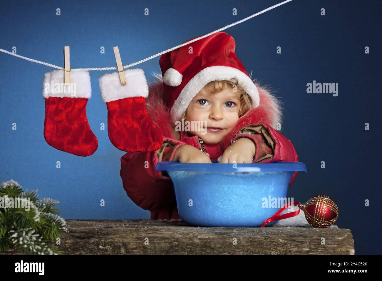 Kind im Weihnachtsmann hat sich im Becken gewaschen. Weihnachtskonzept Stockfoto