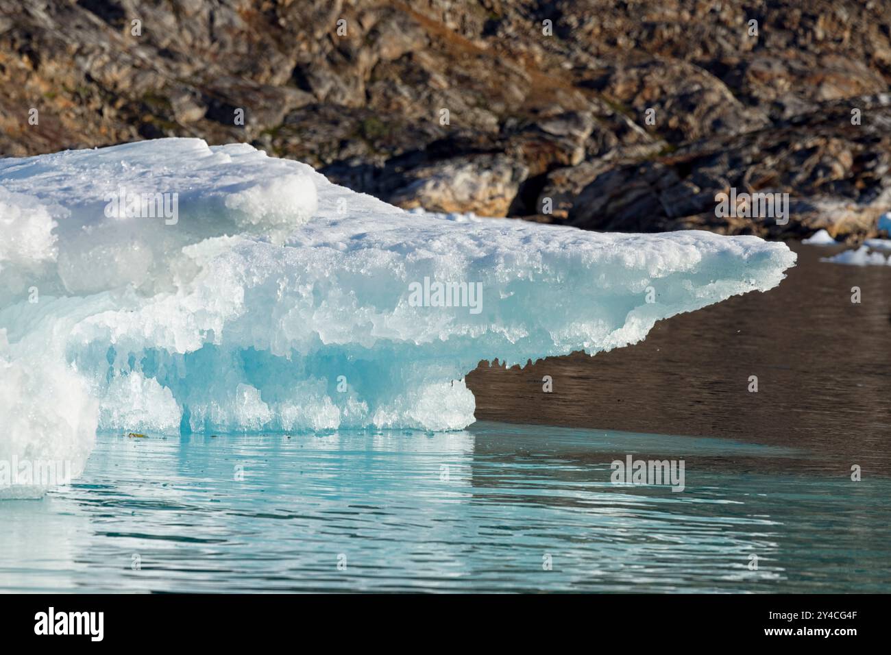 Nahaufnahme eines kleinen schmelzenden Eisbergs in der Nähe der bergigen Küste. Ammassalik Fjord, Ostgrönland, Dänemark Stockfoto