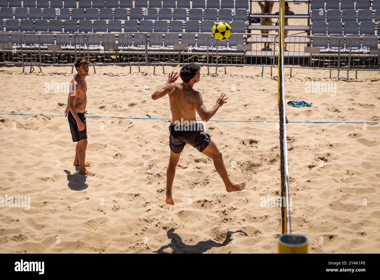 Eine Gruppe von Männern spielt Sepak Takraw oder Fußvolleyball auf einem Sandplatz am Ribeira Beach in Cascais, Portugal Stockfoto