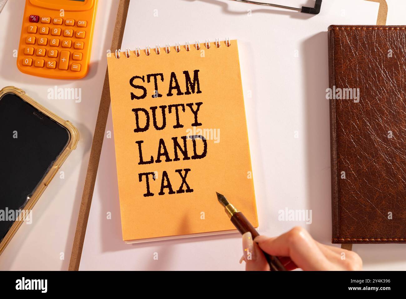 Stempel Duty Land Tax SDLT Text auf gelbem Aufkleber am Notizblock. Zahnräder, Brillen und einen weißen Stift Stockfoto