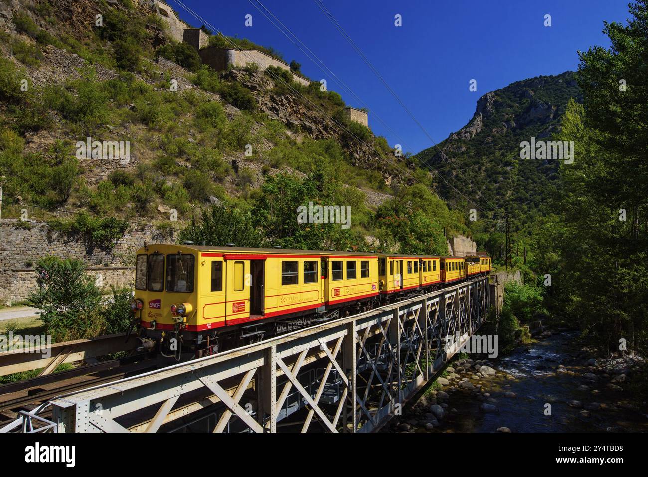 Der kleine gelbe Zug (Le Petit Train Jaune) führt durch Villefranche-de-Conflent, Frankreich, Europa Stockfoto